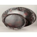 TWO JAPANESE MEIJI PERIOD OVAL SHAPED WOOD & LACQUER TRAYS, the larger with carved decoration of
