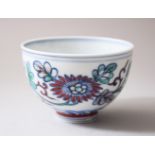 A 19TH CENTURY CHINESE DOCAI PORCELAIN TEA CUP, decorated interior with blue and white floral