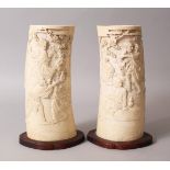 A GOOD PAIR OF JAPANESE MEIJI PERIOD CARVED IVORY TUSK VASES, the tusk sections deeply carved in