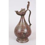 A 12TH-13TH CENTURY PERSIAN BRONZE KHORASAN JUG with Ali Baba lamp spout, 27cm high.