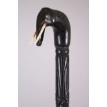 A CEYLONESE CARVED EBONY ELEPHANT HANDLE WALKING STICK, 86cm long.