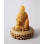 A GOOD CHINESE CARVED SOAPSTONE FIGURE OF LUOHAN & SOAPSTONE BASE, luohan sat holding a ruyi-