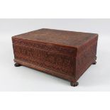 A 19TH CENTURY SRI LANKAN CARVED SANDLEWOOD BOX AND COVER, with fitted interior supported on four