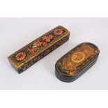 A LARGE PERSIAN LACQUER PEN BOX, 22cm long and lacquer box and cover with shaped ends, 16cm (2).