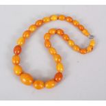 A GOOD CHINESE BUTTERSCOTCH AMBER BEAD NECKLACE, comprising of 31 beads of graduating sizes, 42cm