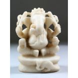 AN EARLY 19TH CENTURY INDIAN CARVED WHITE STONE FIGURE OF GANESH, 12cm high.