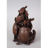 A JAPANESE MEIJI PERIOD CARVED WOOD TURTLE OKIMONO GROUP, the carving finely carved to depict nine