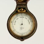 A TRAVELLING BAROMETER, in a leather case.
