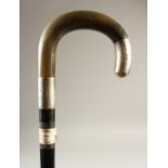 AN EBONY WALKING STICK, with silver mounted horn crook handle. 93cms long.