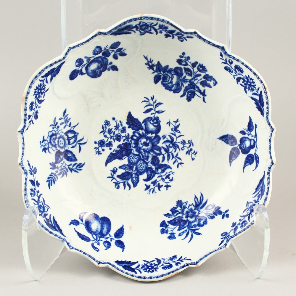 AN 18TH CENTURY WORCESTER BLUE AND WHITE JUNKET BOWL, painted with fruit and shells in relief.