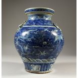 A BLUE AND WHITE BALUSTER SHAPE VASE, decorated with dragons. 28cms high.