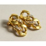 A PAIR OF 18CT GOLD DIAMOND SET EAR CLIPS.