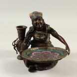 A COLD PAINTED BRONZE OF A SEATED ARAB LADY holding a dish. 17cms high.