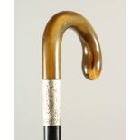 A HORN HANDLED WALKING STICK, with curved handle and engraved silver collar. 88cm long.