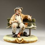 A GOOD CAPODIMONTE PORCELAIN GROUP, old man on a bench feeding doves. 25cm high.