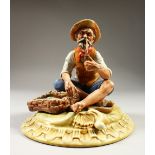 A GOOD CAPODIMONTE PORCELAIN GROUP, old fisherman smoking a pipe, basket of fish by his side. 19cm