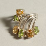 A SILVER, PERIDOT AND CITRINE RING.