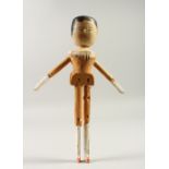 A CARVED WOOD AND PAINTED "PEG DOLL". 29cms high.
