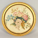 A FRAMED AND GLAZED BRUSSELS OVAL SILKWORK FLOWER.. 34cms diameter.