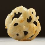 A PIERCED AND CARVED WHITE JADE PENDANT, carved as a horse and dragon. 5cms diameter.