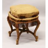 A 19TH CENTURY CONTINENTAL STOOL, with sprung seat, on four velvet covered cabriole legs united by a