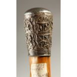A RUSTIC WOOD WALKING STICK, with Chinese embossed silver handle. 77cms long.