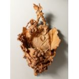 AN UNUSUAL TERACOTTA WALL POCKET, of naturalistic form with brambles and berries. 44cms high.