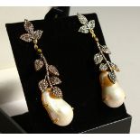 A PAIR OF 9CT GOLD AND SILVER DIAMOND SET BAROQUE PEARL DROP EARRINGS.