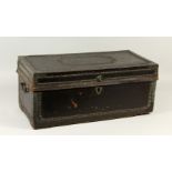 A 19TH CENTURY BRASS BOUND AND STUDDED LEATHER COVERED CAMPHOR WOOD CHEST, with carrying handles.