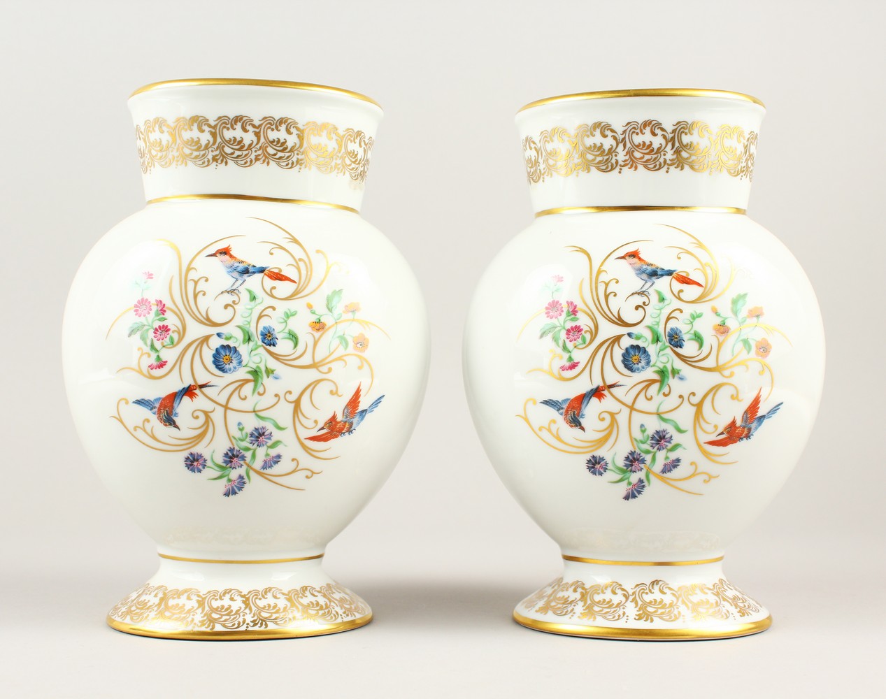 A GOOD PAIR OF LIMOGES CRYSTAL VASES, the white ground painted with birds, flowers and gilt scrolls.