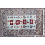 A PERSIAN RUG, pale blue ground, with four large motifs and stylised bird decoration. 152cm x