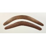 TWO CARVED WOOD BOOMERANGS. 57cms and 62cms wide.