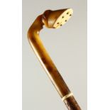 A HORN HANDLED WALKING STICK, with carved horse hoof handle. 85cm long.