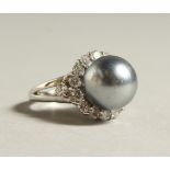 A SILVER GREY PEARL AND CZ RING.