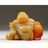 A CARVED JADEITE SEATED BUDDHA. 6.5cms wide.