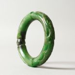 A DARK GREEN JADE BANGLE. 8cms diameter.