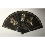 A LARGE FRENCH LACE AND MOTHER-OF-PEARL FAN, black with angels. 60cms wide open.
