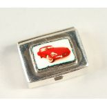 A SMALL SILVER PILL BOX, decorated with a car.