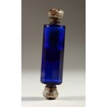 A VICTORIAN BRISTOL BLUE DOUBLE ENDED SCENT BOTTLE with silver tops. 10cms long.
