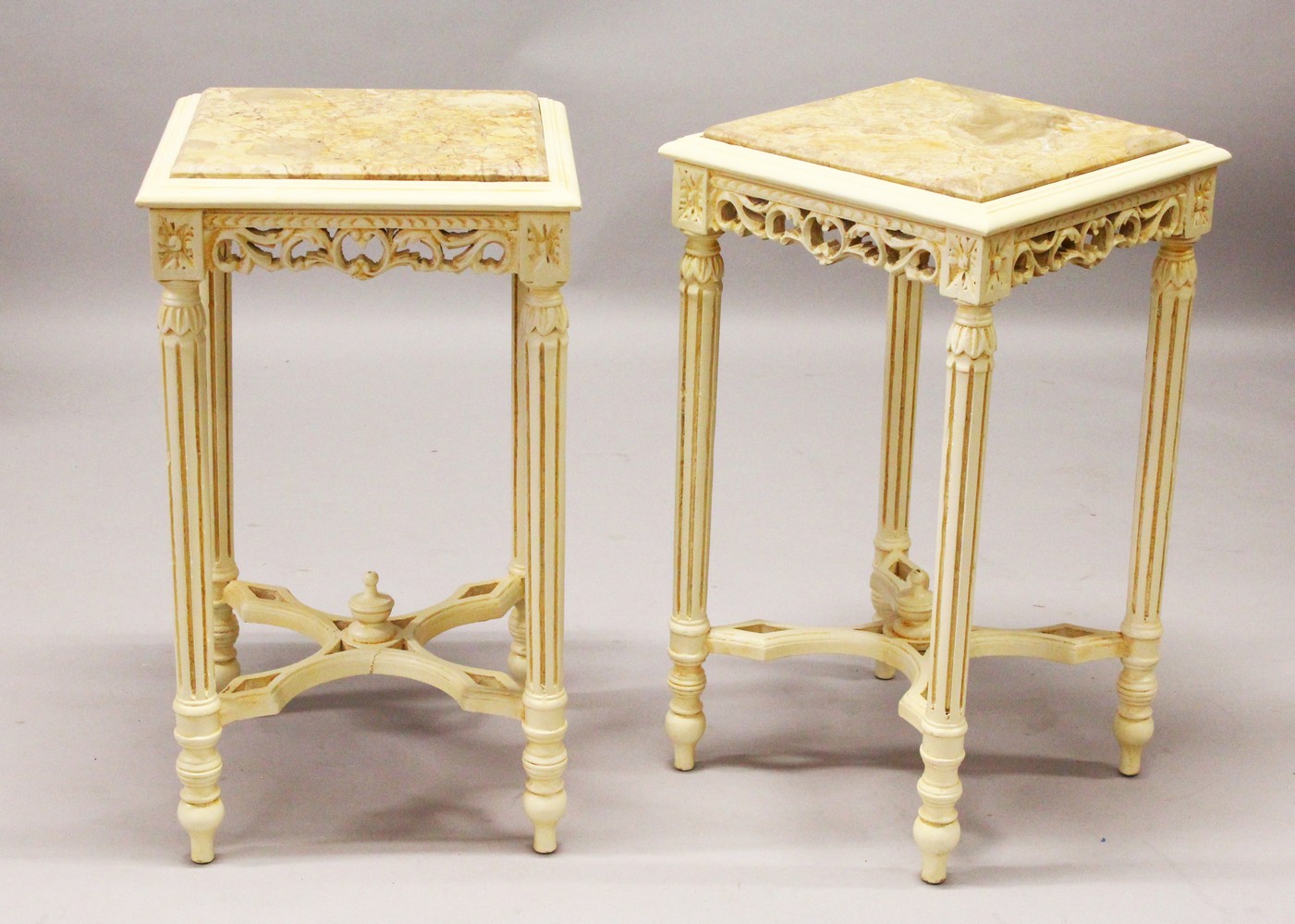A PAIR OF FRENCH STYLE CREAM PAINTED SQUARE SHAPE TABLES, with inset marble tops. 42cm wide x 72cm