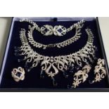 A SILVER AND FAUX SAPPHIRE FOUR PIECE SET, necklace, ring and earrings.