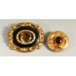 A VICTORIAN GOLD AND CITRINE BROOCH and A SMALLER BROOCH.