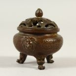 A SMALL BRONZE CIRCULAR CENSER, with pierced lid. 5cms wide.