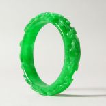 AN APPLE GREEN JADE BANGLE. 7.5cms diameter.