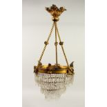 A 19TH/20TH CENTURY ORMOLU HANGING LIGHT FITTING, with three tiers of cut glass prism drops. 62cms