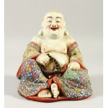 A POLYCHROME DECORATED SEATED BUDDHA. 20cms high.