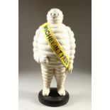 A LARGE CAST IRON AND PAINTED MODEL OF THE MICHELIN MAN. 59cms high.