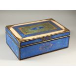 AN UNUSUAL DECOUPAGE STYLE BOX, covered with blue marbled paper. 39cms wide.