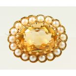 A SMALL 9CT GOLD, CITRINE AND SEED PEARL OVAL BROOCH.