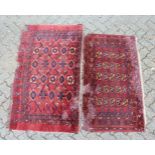 TWO SMALL PERSIAN RUGS, rust ground with stylised floral medallions (moth damage). 150cm x 85cm